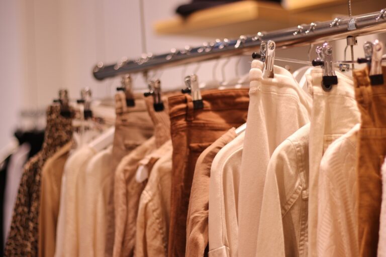 Beige and tall clothes hanging in a closet