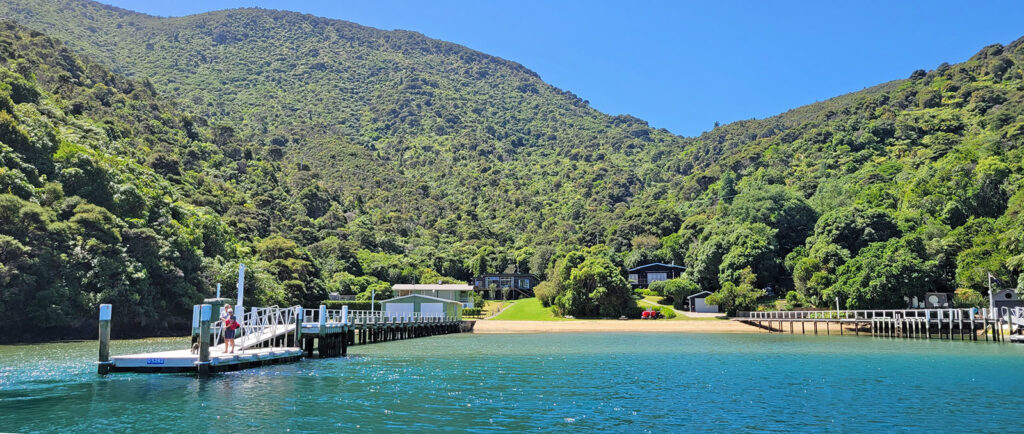 Approach by boat to a house in Queen Charlotte Sound, NZ