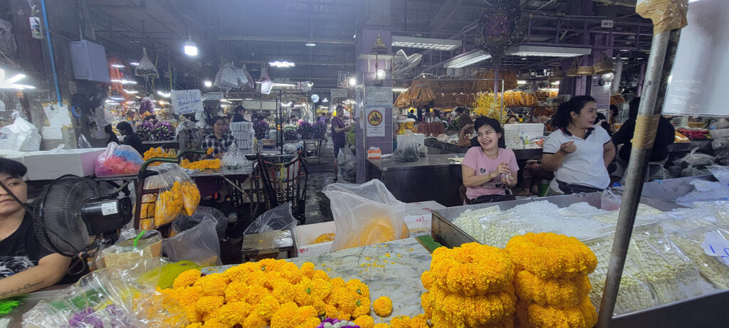 People working at night in a wholesale flower warehouse.