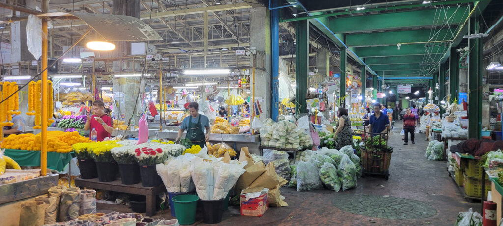 A wholesale flower warehouse in Bangkok at night.