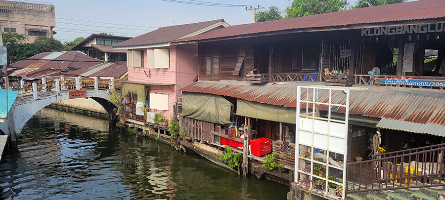 Shops and an artist studio along a canal in Bangkok