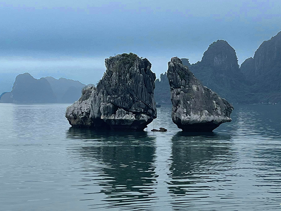 Two rocks in Ha Long Bay Vietnam that are referred to as the Rooster and the Hen