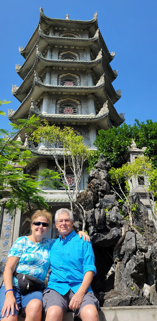 Cathy and Mark sitting in front of a pagoda on Thuy Son Mountain in Da Nang
