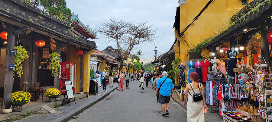 People walking through the streets of the ancient town of Hoi An, Vietnam.