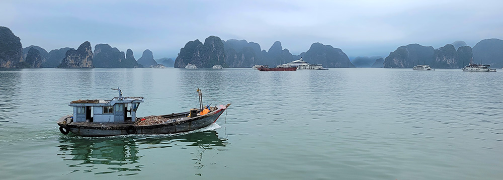 Scene on Ha Long Bay with small boat in the foreground