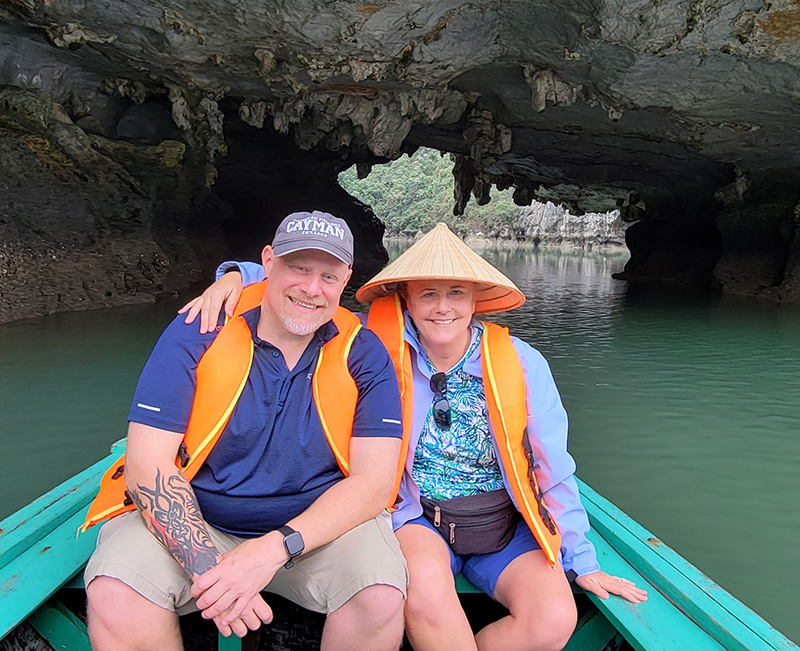 A man and woman in a row boat in Ha Long Bay Vietnam