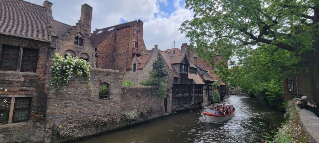 A canal boat traveling through Bruges, Belgium.