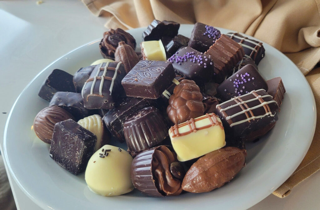 A plate piled with an assortment of Belgian chocolates