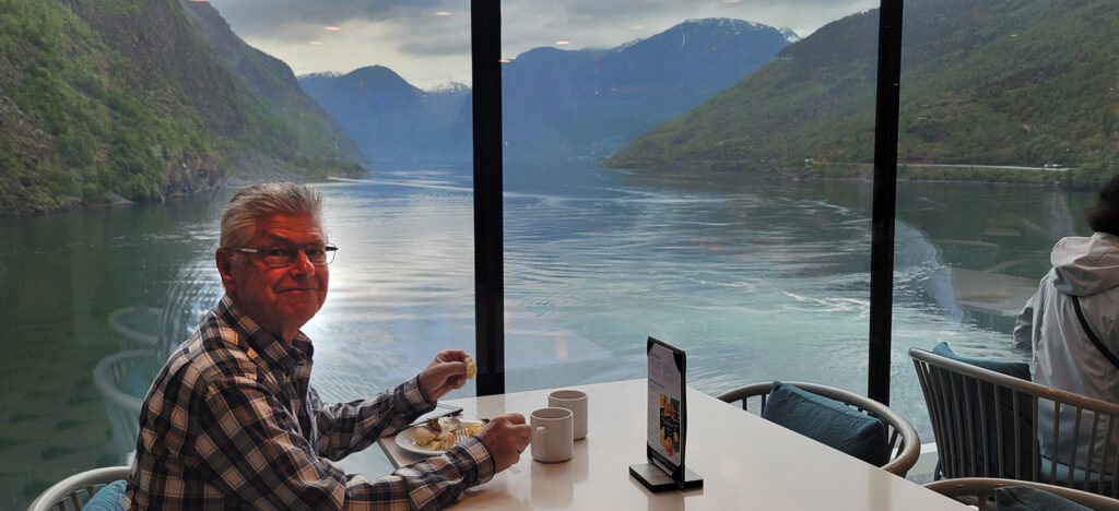 A man eating breakfast in the buffet of the Celebrity Apex as the ship sails through Sognefjord in Norway.