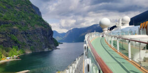 The Celebrity Apex ship sailing through the Geiranger Fjord in Norway.