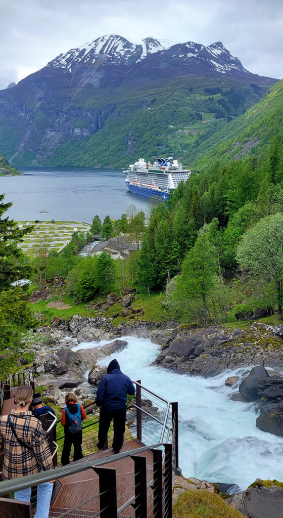A walkway following a stream heading down to Geiranger, Norway harbor.