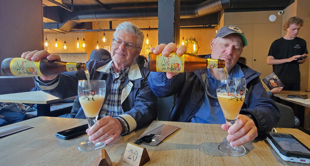 Two men pouring beers