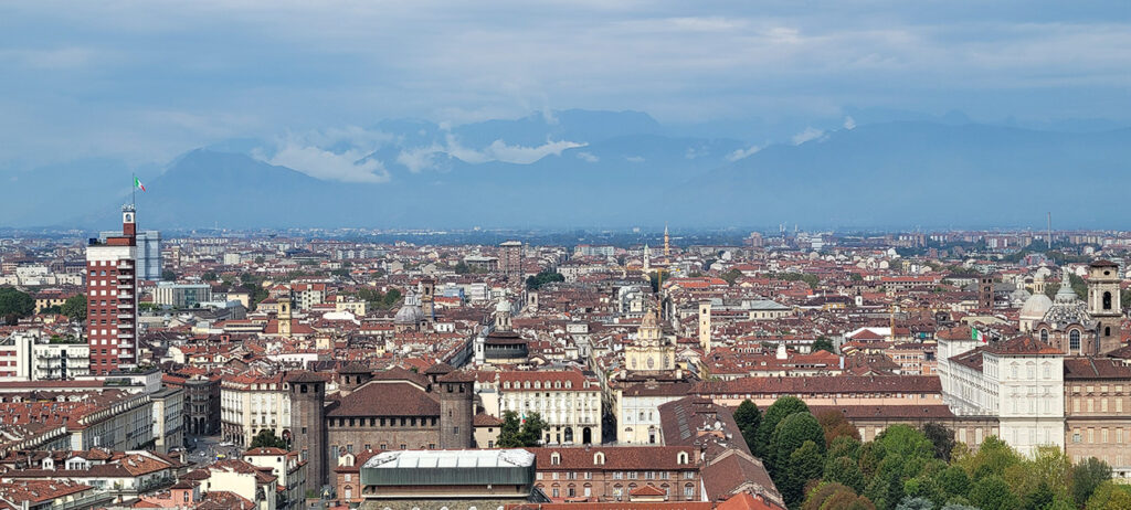 a sweeping view of Turin with the alps in the background