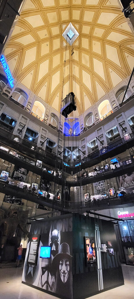 The interior of the National Museum of Cinema in Turin, Italy. It is a tall open building with an elevator going up through the middle
