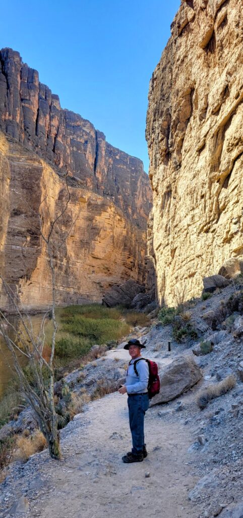 A man standing in a narrow canyon
