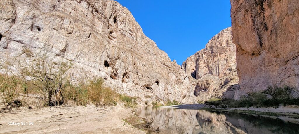 Canyon walls with a small river running through it.
