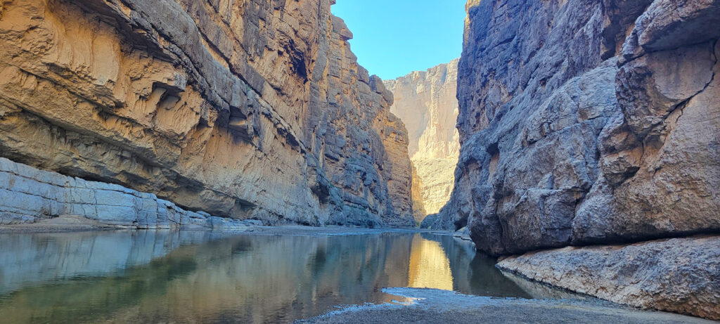 view down Santa Elana canyon with sunlight lighting the canyon in the distance